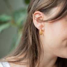Load image into Gallery viewer, Woman wearing gold croissant style hoop earrings