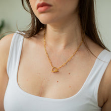 Load image into Gallery viewer, Woman wearing a gold toggle necklace with a minimal background
