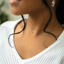 Load image into Gallery viewer, Close-up of a person wearing a delicate necklace with a blurred background
