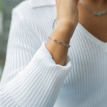 Load image into Gallery viewer, Person wearing silver jewelry and a white sweater with a blurred background
